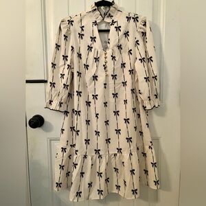Brand new never worn white cream dress with navy bows and gold buttons
